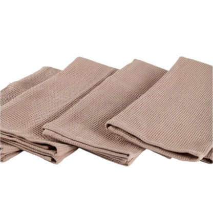 Four light brown waffle-textured kitchen towels arranged in a cascading fold pattern on a white background, showcasing their texture and uniformity.