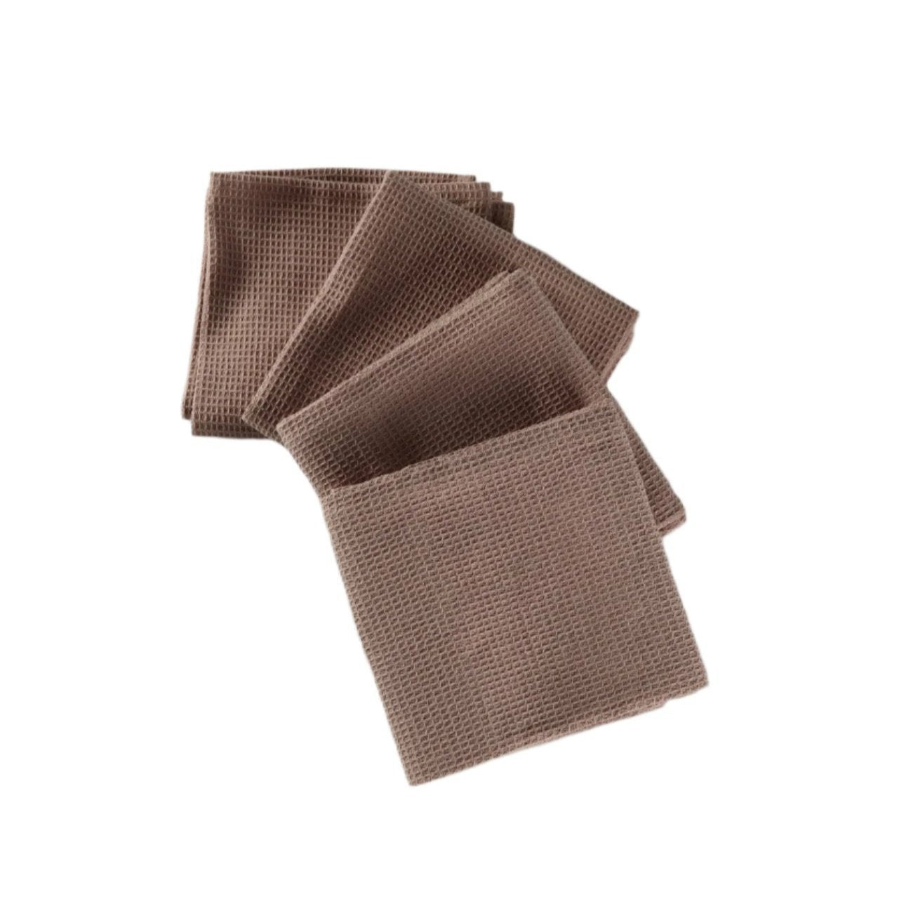 Four light brown waffle-textured cottonkitchen towels stacked and slightly fanned out on a white background, showcasing their texture and color.