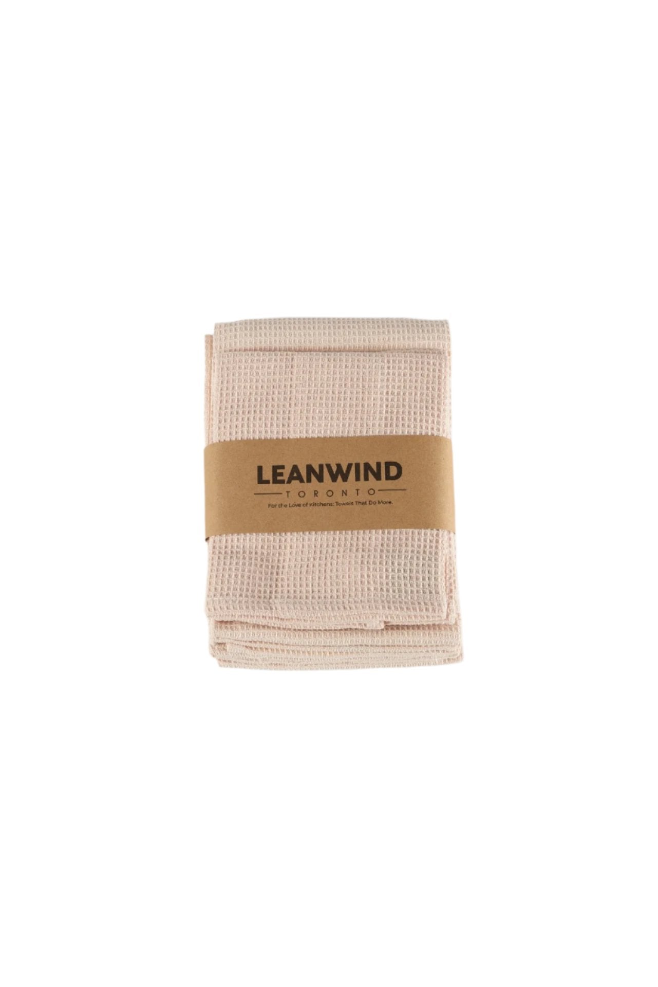 Folded light pink waffle-textured kitchen towels with a brown paper band labeled &quot;LEANWIND TORONTO&quot; wrapped around the middle, displayed on a white background.